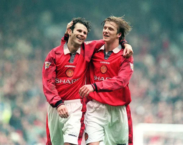 Manchester United footballer Ryan Giggs celebrates a goal with teammate David Beckham