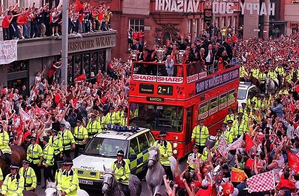 Manchester United Homecoming on an open-top bus May 1999 mobbed by fans at the start of