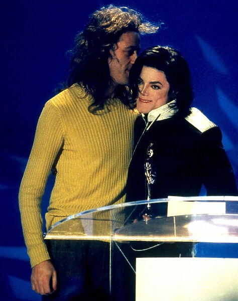 Michael Jackson accepts his award from Bob Geldof at the 1996 Brit Awards