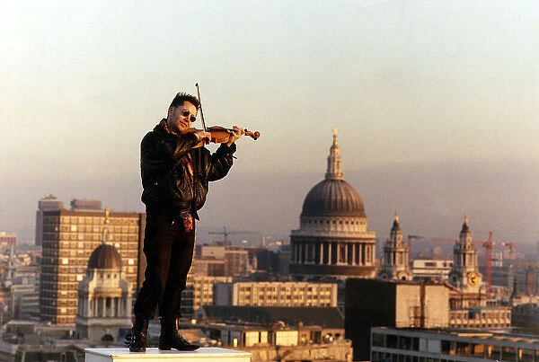 Nigel Kennedy the violinist playing his violin overlooking London
