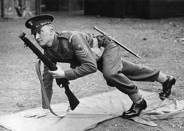 An officer from the Grenadier Guards getting into a laying combat position