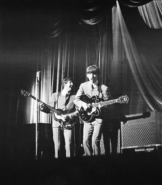 Paul McCartney and George Harrison onstage as The Beatles play at ABC Cinema, Northampton