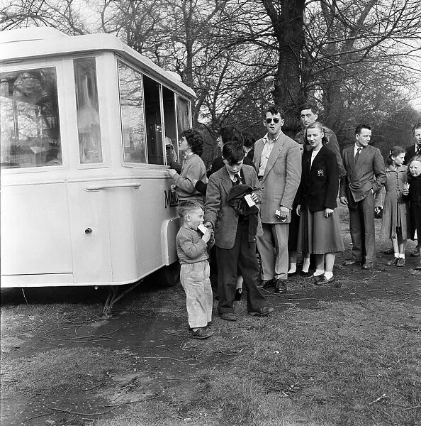 People buying refreshments in Kensington Gardens, London. 25th April 1955