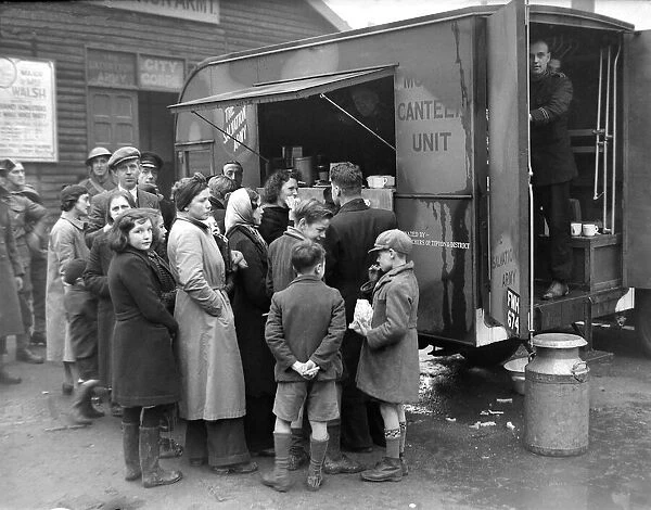 People gather around the mobile canteen van situated at the Salvation Army in Coventry