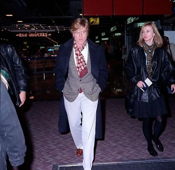 Robert Redford actor at London airport with unidentified womam