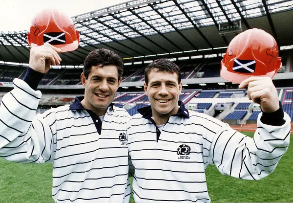 Scott Hastings and Gavin Hastings of the Scotland rugby squad standing in stadium holding