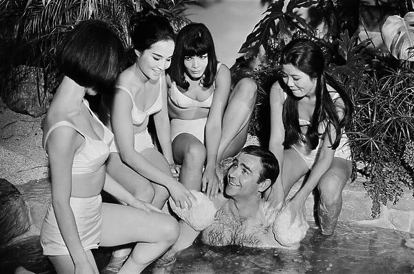 Sean Connery in his roles as James Bond being washed by a group of ladies in a scene
