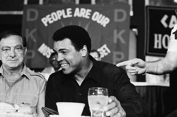 A smiling Muhammad Ali at pre fight press conference for his upcoming fight with Larry