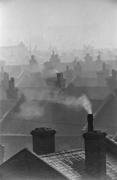 Smog caused by coal fires hangs over the roof tops of Battersea, London