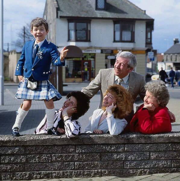 Stuart Anderson April 1989 child Andy Stewart impersonator standing on a wall watched by