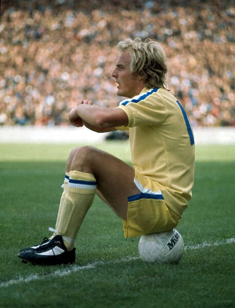Terry Yorath sitting on a football Leeds United. December 1975