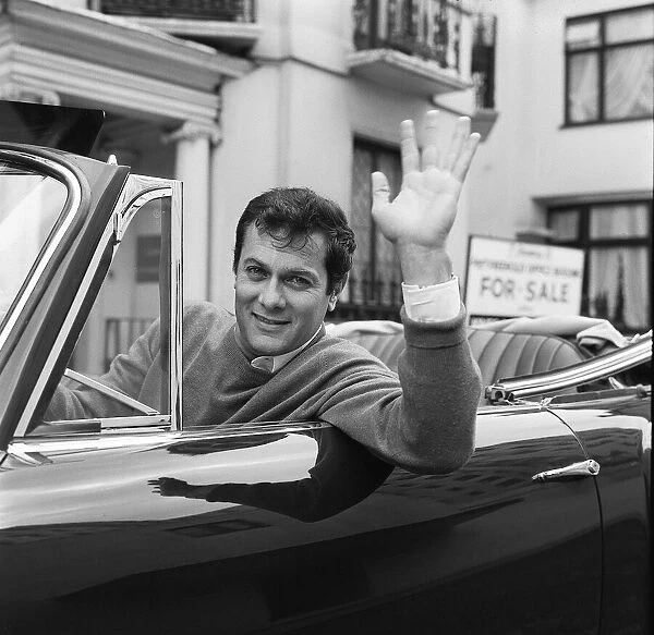 Tony Curtis, american actor poses for pictures in his Alvis