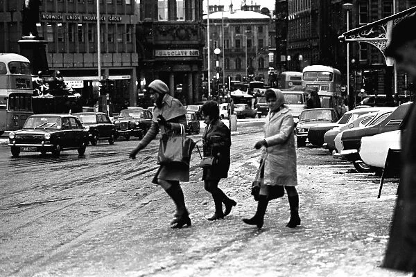 Traffic and pedestrains struggle against the snow on Neville Street