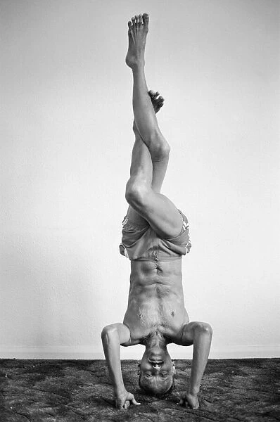 Yoga positions. Position is called Eagle in Tripod Headstand