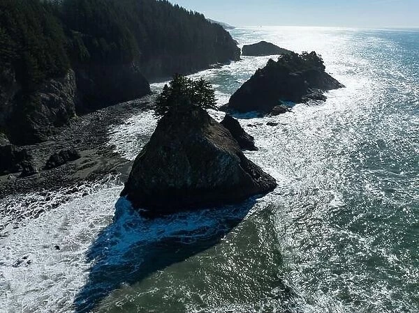 Afternoon sunlight shines on the scenic southern coast of Oregon. This rugged region is found in the Samuel H. Boardman State Scenic Corridor