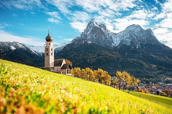 St. Valentin (Kastelruth) Village Church at the autumn Dolomite Alps. Amazing landscape with small chapel on sunny meadow