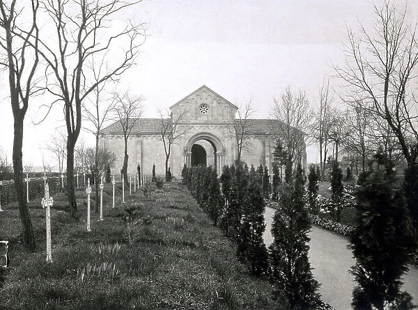 Cemetery of Gravellotte (France). In the background, the entrance gates incorporated in an architectural structure in romanesque style