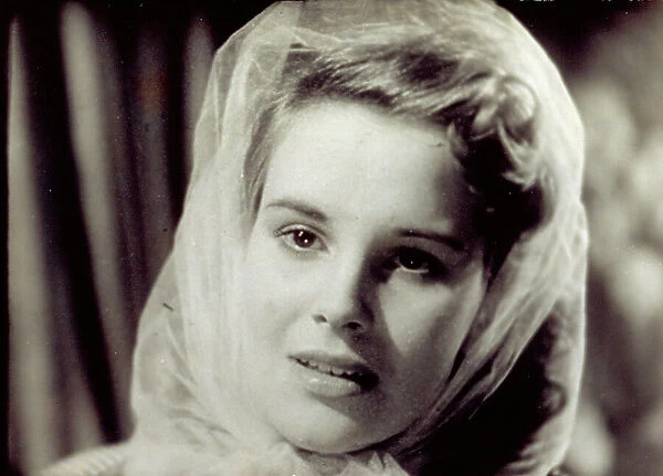 Close-up of the italian actress Antonella Lualdi, probably taken during the shooting of a film. The actress has her face framed by a veil
