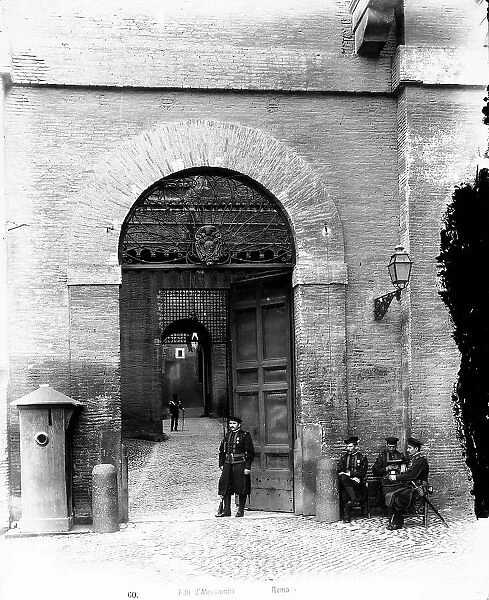 Some guards in front of the doors to the entrance of the Vatican Palaces. Vatican City