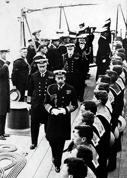 H.M. King George of Windsor, reviewing the navy seamen of the supership Iron Duke, before leaving for the battle. The monarch is on the ship deck, flanked by British royal navy senior officers