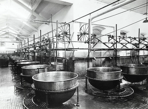 Interior of a factory with big pots used for cheese production