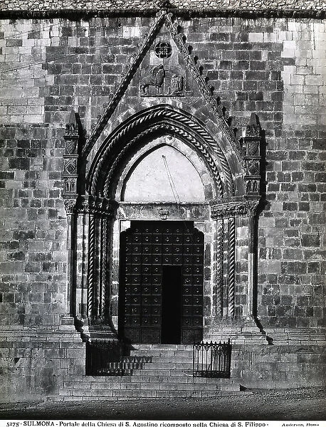 Pointed portal of the Church of S. Agostino, rebuilt in the Church of S. Filippo, Sulmona. The portal has a bas-relief depicting St. Martin giving a cloak to a poor person in the cuspid pediment