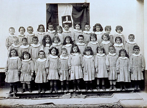 Portrait of the pupils of the Foce nursery school in the Sampierdarena district of Genoa. In the background the italian flag
