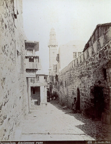 View of an ancient street of Jerusalem. In the background a Minaret