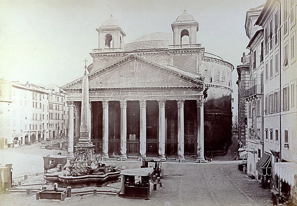 View of the Pantheon and the fountain in front, in Rome. Four kiosks on either side of the fountain