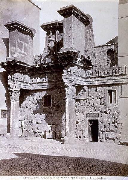 View of the remains of the portico of the Temple of Minerva, in Rome. Two columns support an attic with a high relief frieze