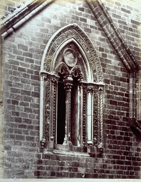 A window in gothic floral style of a facade of the Duomo of