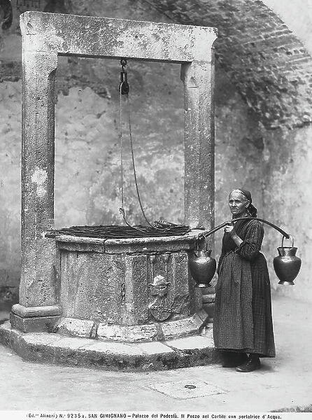 A woman photographed near the well of the courtyard in Palazzo del Podest, in San Gimignano