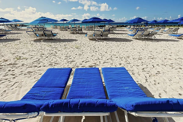 Barbados, empty lounge chairs and beach umbrella