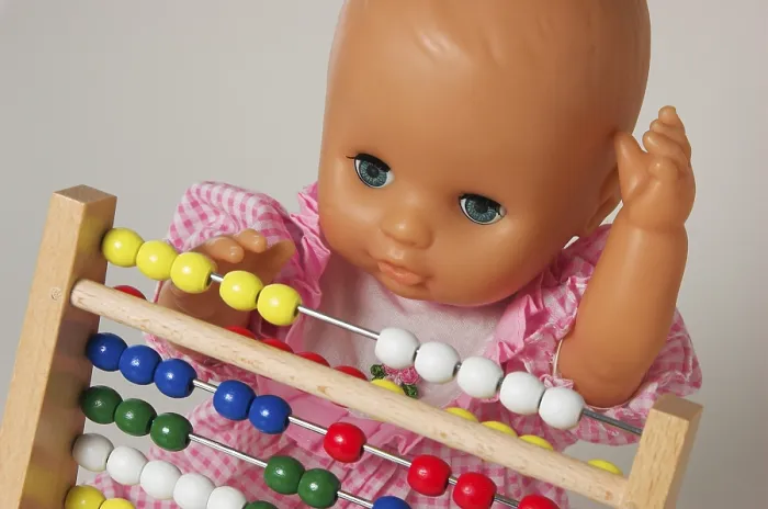 Framed Print : Learning Arithmetics, Doll Using an Abacus Print Framed Print : Learning Arithmetics, Doll Using an Abacus Print
