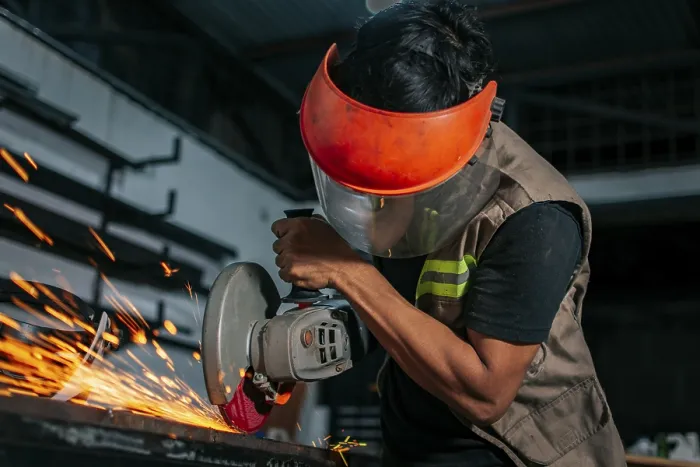 Framed Print : Metalworking Professional Using an Angle Grinder Print