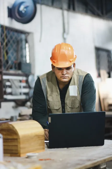 Framed Print : Print of Carpenter Working with Laptop in Workshop
