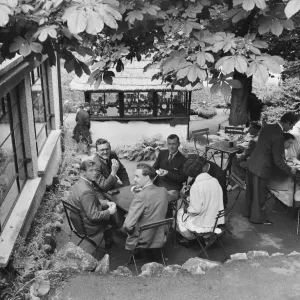 Print of people seated outside a cafe in Cheddar, Somerset Print of people seated outside a cafe in Cheddar, Somerset