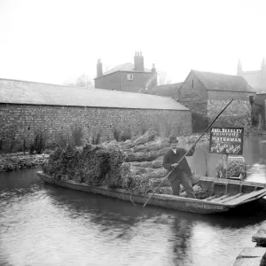 Print of Abel Beesley on his punt with bundles of rushes near Pacey Bridge Print of Abel Beesley on his punt with bundles of rushes near Pacey Bridge
