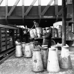 Print of Railway Workers Collecting Milk Churns at Paddington Station Print of Railway Workers Collecting Milk Churns at Paddington Station