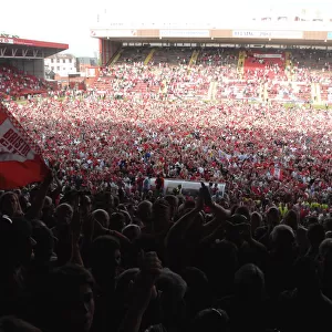 Celebrating Promotion: Thrilled Fans Invade the Pitch at Bristol City Football Club