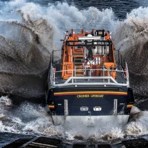 Cromer Tamar class lifeboat Lester 16-07 launching down the slipway, lots of white spray