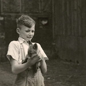 Boy holding a fox cub