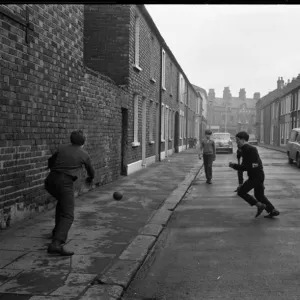 Boys playing football in a street, Belfast, Northern Ireland