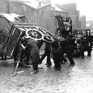 Firefighters attempt to right a fallen cart, WW2