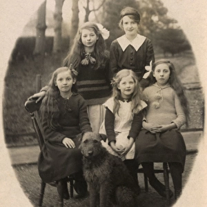 Five girls and dog in garden