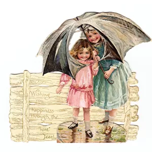 Two girls with umbrella on a cutout New Year card