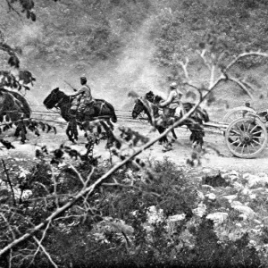 A heavy gun battery moving uphill during the Balkan campaign