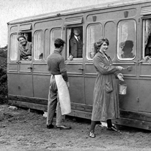 Holidaymakers painting a railway carriage