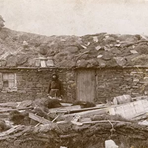A Local Woman of the Orkney Islands outside her house