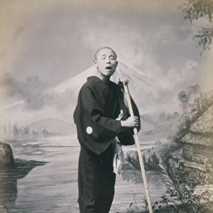 Man with staff, wearing geta, studio portrait